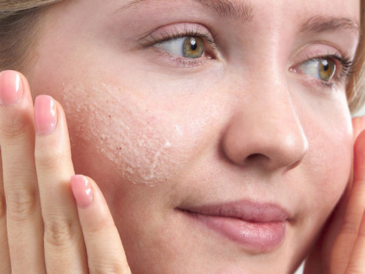 Image of women applying a face scrub to her cheeks