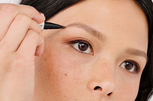 Model applying Benefit Mighty Fine Brow Pen