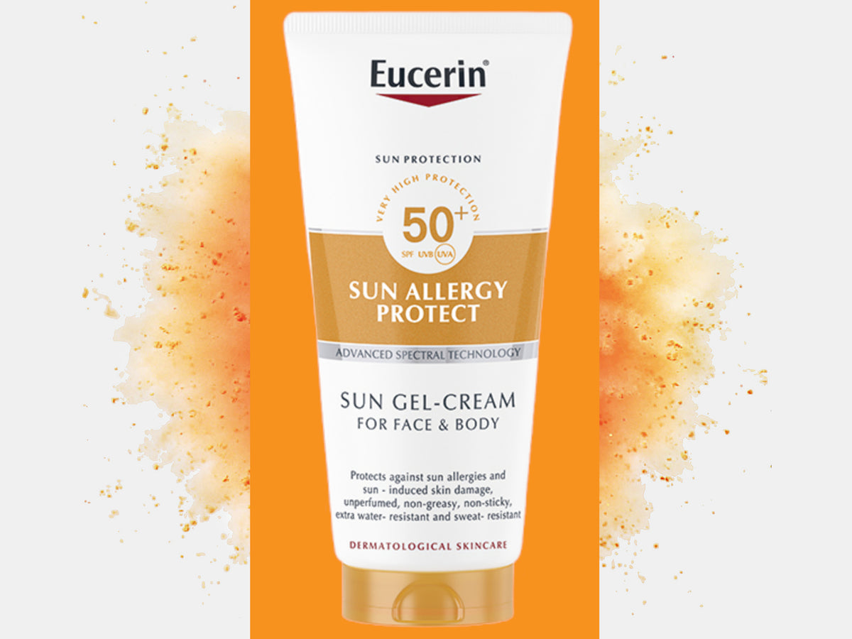 Eucerin Sun Allergy Protect Sun Gel-Cream for Face and Body SPF50+ in a white and orange tube, on an orange panel with a burst of orange powder